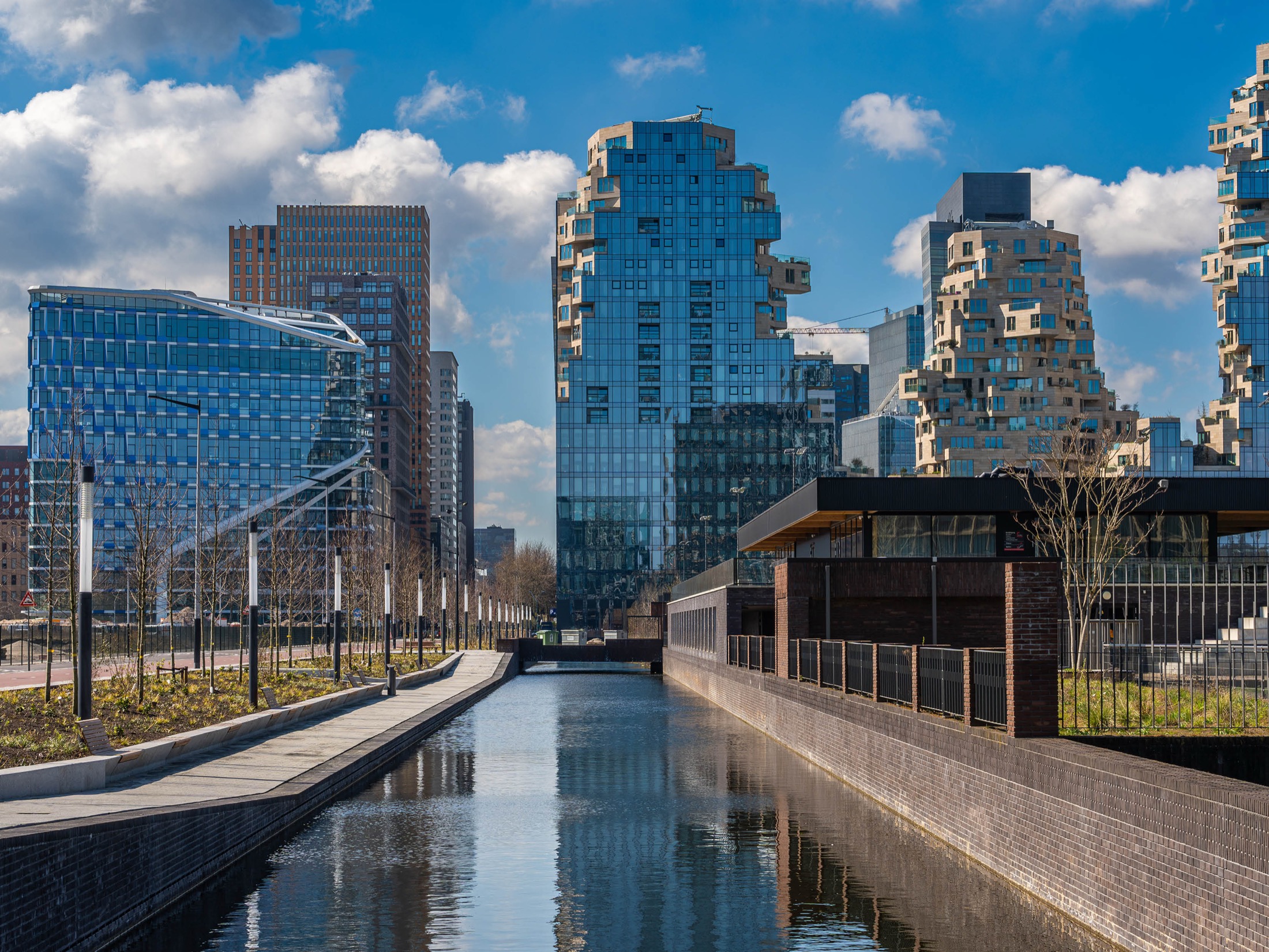 Exterieur van de Zuidas in Amsterdam met moderne kantoortorens en waterpartij — locatie van BotanicBite